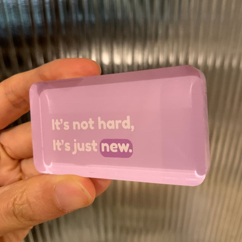Pink rectangular magnet with motivational text "it's not hard, it's just new"
