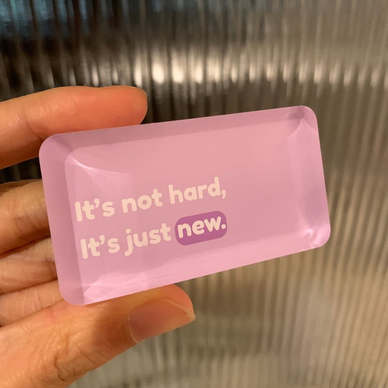 Pink rectangular magnet with motivational text "it's not hard, it's just new"