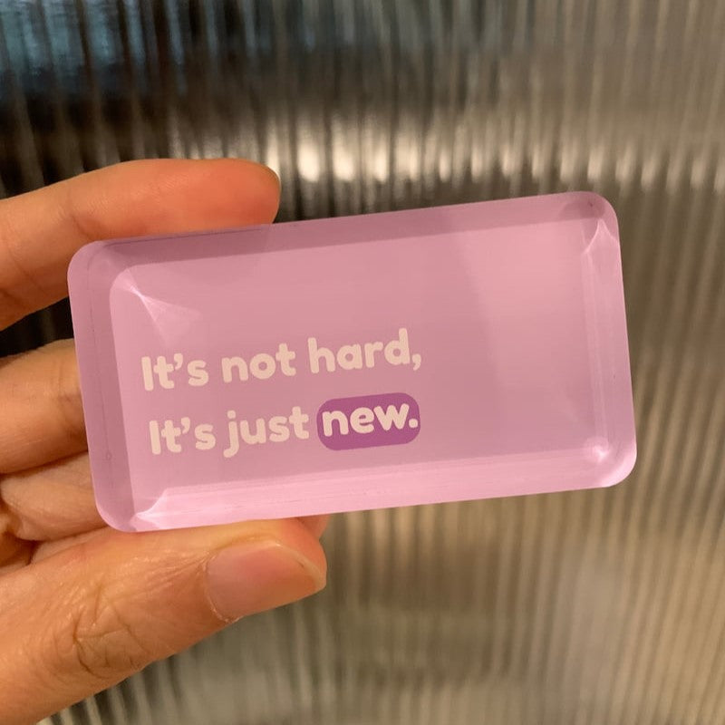 Pink rectangular magnet with motivational text "it's not hard, it's just new"